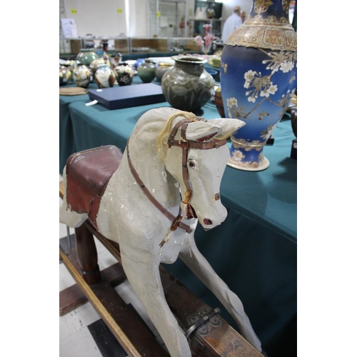 1367 - ANTIQUE ROCKING HORSE a painted rocking horse mounted on a wooden trestle stand, fitted with a saddl... 