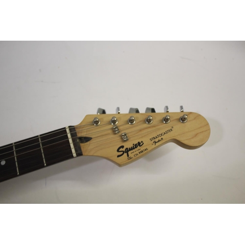 1441 - FENDER STRATOCASTER SQUIER GUITAR - KOREA with a black and white finish and three control dials, and... 