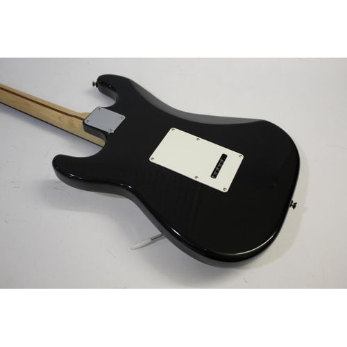 1441 - FENDER STRATOCASTER SQUIER GUITAR - KOREA with a black and white finish and three control dials, and... 