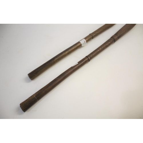 1473 - TRIBAL WAR CLUB of pointed form, the shaft with cross hatch carving, 81cms long. Also with another t... 