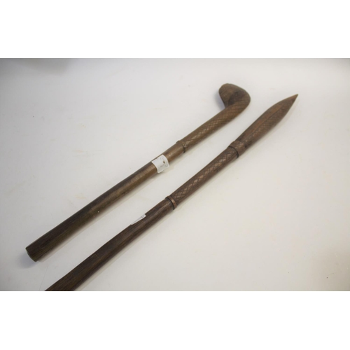 1473 - TRIBAL WAR CLUB of pointed form, the shaft with cross hatch carving, 81cms long. Also with another t... 