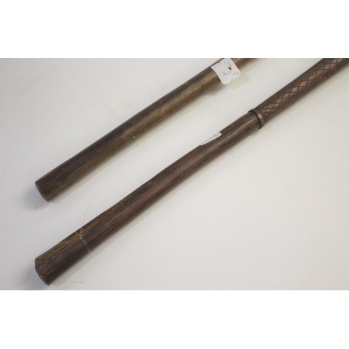 1473 - TRIBAL WAR CLUB of pointed form, the shaft with cross hatch carving, 81cms long. Also with another t... 