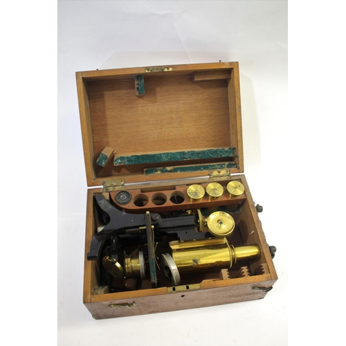 1479 - CASED MICROSCOPE - SWIFT & SON a brass and metal monocular microscope, in a fitted mahogany case and... 