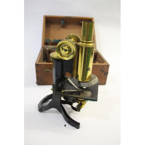 1479 - CASED MICROSCOPE - SWIFT & SON a brass and metal monocular microscope, in a fitted mahogany case and... 