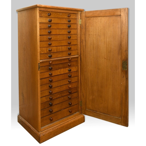 1485 - OAK COLLECTORS CABINET a late 19thc or early 20thc cabinet, with 18 internal drawers (each drawer wi... 