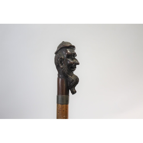 1510 - CARVED TOP WALKING STICK the top carved in the form of a gentleman with a long beard, with a metal c... 