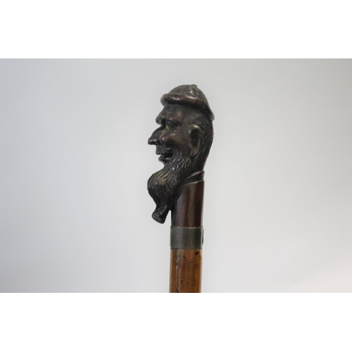 1510 - CARVED TOP WALKING STICK the top carved in the form of a gentleman with a long beard, with a metal c... 