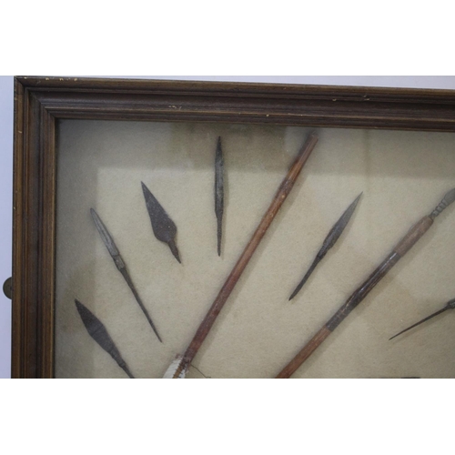 1511 - FRAMED ARROW HEADS a cased display with various metal arrow heads and shafts, with an information la... 