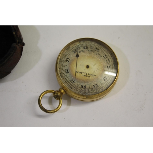 1513 - NEGRETTI & ZAMBRA POCKET BAROMETER a brass cased pocket barometer with a silvered dial and in a fitt... 