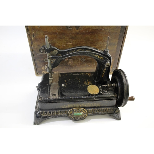 1520 - NEW AMERICAN CAST IRON SEWING MACHINE - CASED a late 19thc New American cast iron sewing machine, wi... 