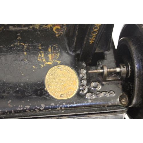 1520 - NEW AMERICAN CAST IRON SEWING MACHINE - CASED a late 19thc New American cast iron sewing machine, wi... 