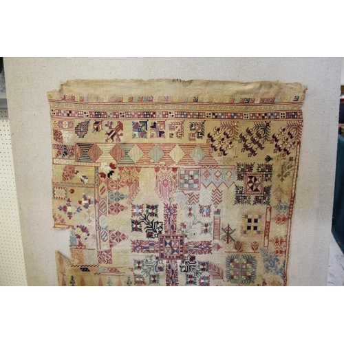 1575 - 18THC/19THC MOROCCAN SAMPLER a large 18th or 19thc embroidered sampler, carefully mounted on a hessi... 