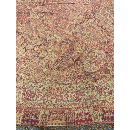 1612 - PAISLEY SHAWL a large paisley shawl with typical colours and motifs including boteh, with a fringe a... 