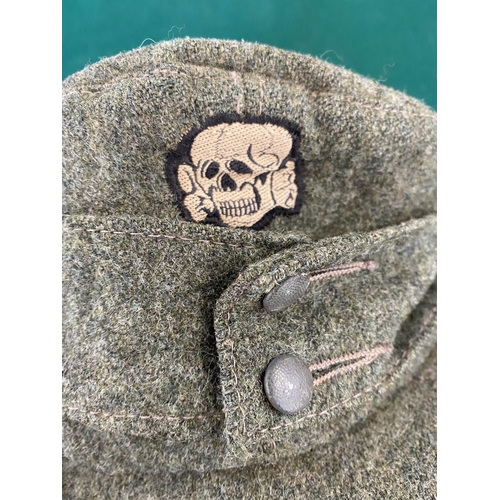 681 - A SECOND WORLD WAR OR LATER 'SS TOTENKOPF' CAP. A green fabric forage cap with skull and cross bones... 