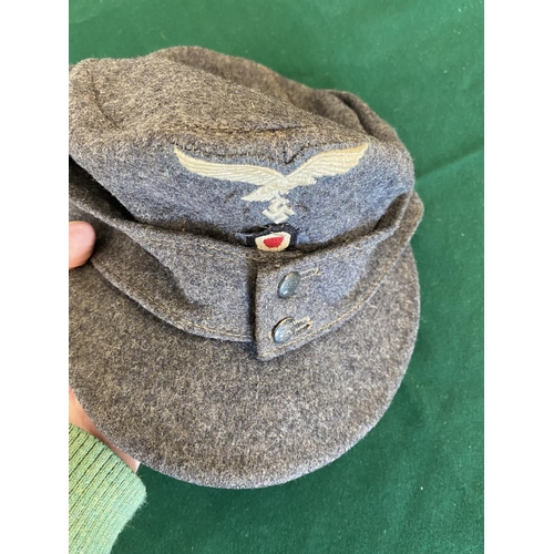 681a - A SECOND WORLD WAR OR LATER LUFTWAFFE FORAGE CAP.
A grey forage or ski cap with Luftwaffe eagle and ... 