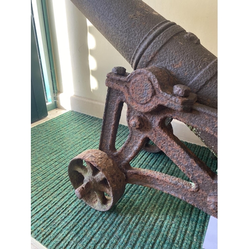 568 - A PAIR OF CAST IRON CANNON ON CARRIAGES. With 95cm long barrels cast with a crown at the pivot point... 