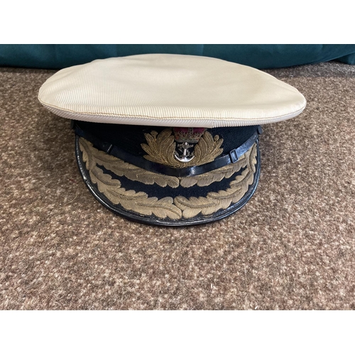 896 - A COLLECTION OF ROYAL NAVY OFFICERS CAPS. A dark blue peaked officers cap with King's Crown by Sande... 