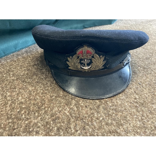 896 - A COLLECTION OF ROYAL NAVY OFFICERS CAPS. A dark blue peaked officers cap with King's Crown by Sande... 