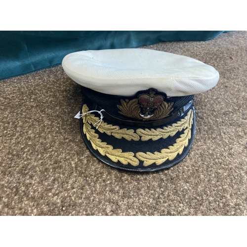 896 - A COLLECTION OF ROYAL NAVY OFFICERS CAPS. A dark blue peaked officers cap with King's Crown by Sande... 