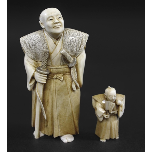 1104 - JAPANESE SIGNED IVORY OKIMONO - OKUBO Meiji period, a detailed carved ivory of a gentleman, holding ... 