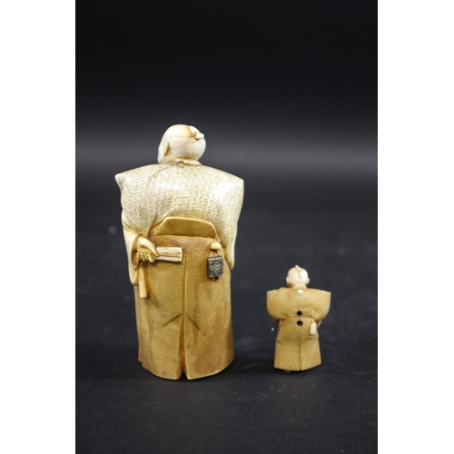 1104 - JAPANESE SIGNED IVORY OKIMONO - OKUBO Meiji period, a detailed carved ivory of a gentleman, holding ... 