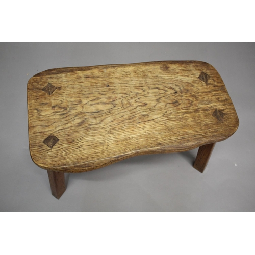 872 - GNOMEMAN OAK STOOL - THOMAS WHITTAKER (1910-1991) a large adzed stool with a shaped oak top, support... 