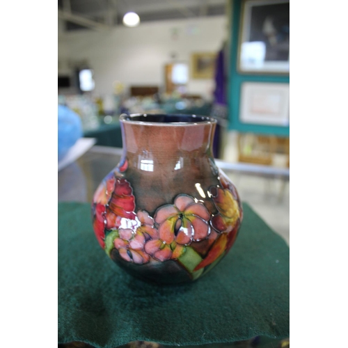 899 - MOORCROFT FLAMBE VASE - ORCHID a squat vase painted in the Orchid design, and with a flambe glaze. M... 