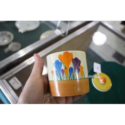 905 - CLARICE CLIFF SUGAR SIFTER a conical shaped sugar sifter in the Crocus design, also with a lidded pr... 