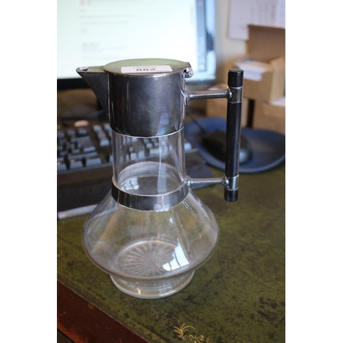882 - ARTS & CRAFTS CLARET JUG - MAPPIN BROTHERS in the manner of Christopher Dresser, with a glass body a... 