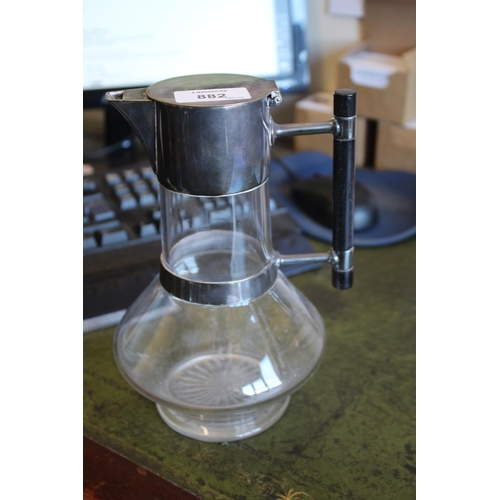882 - ARTS & CRAFTS CLARET JUG - MAPPIN BROTHERS in the manner of Christopher Dresser, with a glass body a... 