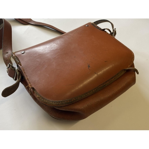 471 - A BROWN LEATHER CARTRIDGE BAG. A light brown shoulder cartridge bag with buckle fastening and should... 