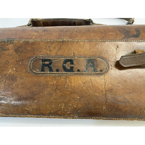 477 - A LEATHER LEG O MUTTON GUN CASE. A brown leather gun case with carrying handle and strap, painted wi... 