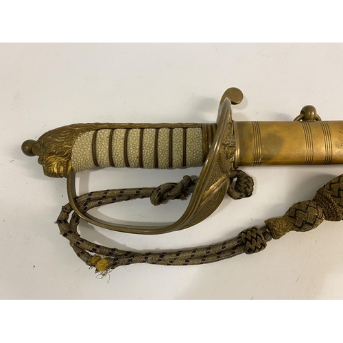 511 - A NAVAL OFFICERS SWORD AND SCABBARD. A mid 20th Century Naval Officers sword with an 80cm blade with... 