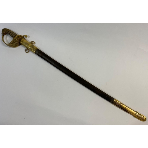 513 - A NAVAL OFFICERS SWORD AND SCABBARD. A Naval Officers sword with a slightly curved 73cm pointed, sin... 