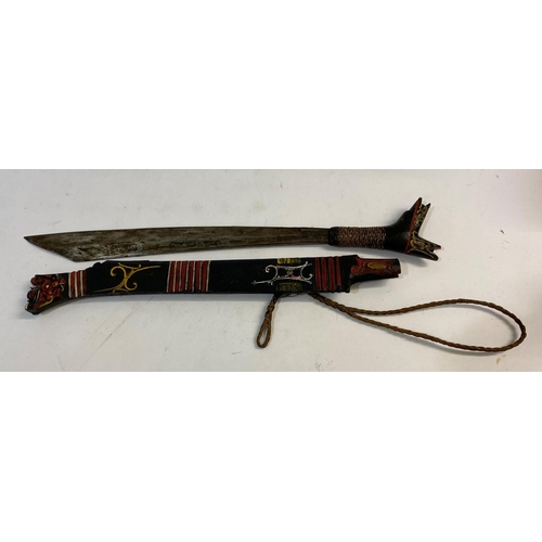 539 - A BORNEO DYACK 'HEAD HUNTERS' SWORD AND SCABBARD. A sword with a 44cm shaped pointed blade with shar... 