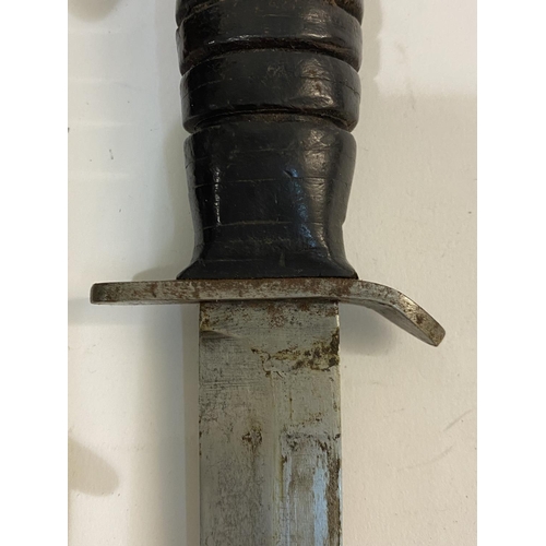 545 - A US M3 FIGHTING KNIFE AND SCABBARD BY UTICA. With a 17cm pointed blade with double sided point, the... 