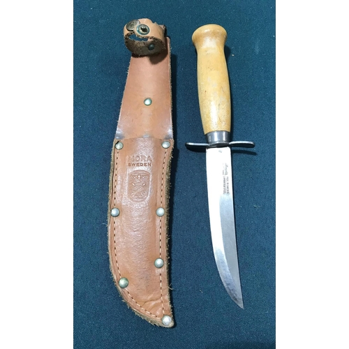 570 - A HUNTING KNIFE BY MORA OF SWEDEN. A beech handled steel bladed hunting knife, the 12cm blade marked... 