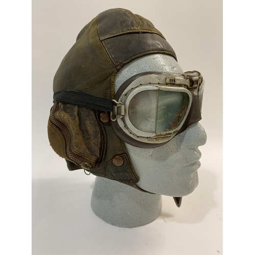 601 - A SECOND WORLD WAR PILOTS FLYING HELMET AND PEAKED CAP. A Type B flying helmet, 1936-41 with a pair ... 