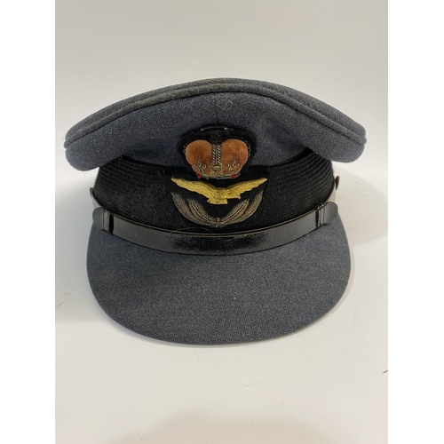 601 - A SECOND WORLD WAR PILOTS FLYING HELMET AND PEAKED CAP. A Type B flying helmet, 1936-41 with a pair ... 