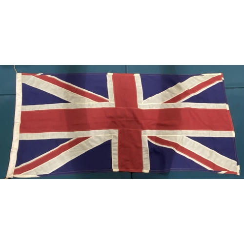 602 - A LARGE UNION FLAG. A Union flag (Union Jack) 87 x 180 cm, of sewn construction with wooden toggle t... 