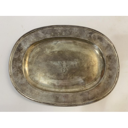 669 - A GERMAN SS PLATED SERVING DISH. An oval serving platter with a central Eagle with wings outstretche... 