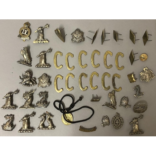 696 - A SMALL COLLECTION OF MILITARY BADGES AND FITTINGS. A collection of badges including an 'Oxford' sho... 