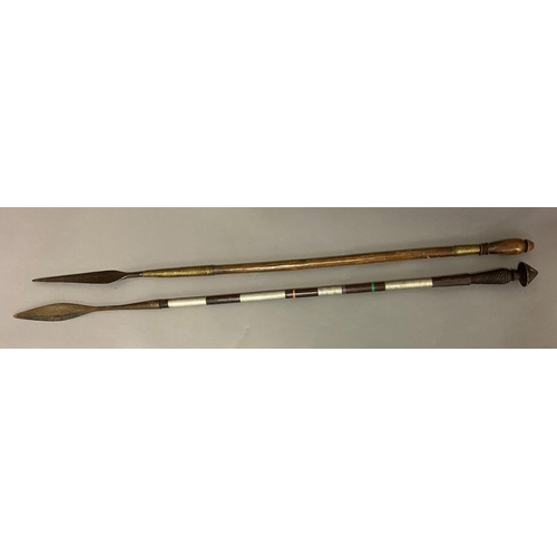 572 - TWO ZULU OR SIMILAR THROWING SPEARS. A wooden shafted throwing spear with a long leaf shaped blade w... 