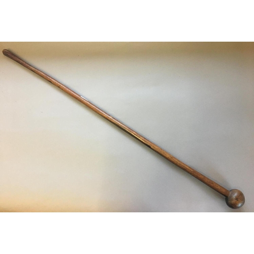 578 - A LONG HANDLED KNOB KERRY. A hard wood knob kerry or throwing stick with bulbous end, 97cm.