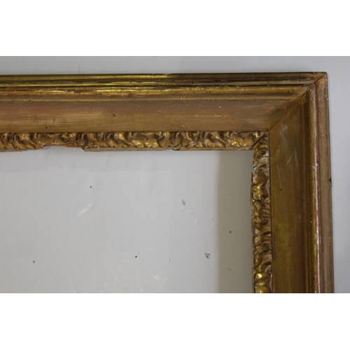 595 - A `CARLO MARATTA` TYPE GILTWOOD PICTURE FRAME with stylised leaf sight edge To fit 55.5 x 76cm.appro... 