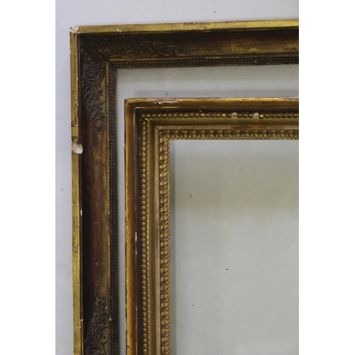 596 - TWO GILTWOOD PICTURE FRAMES one with floral decoration to the frieze corners, the other with bead- a... 