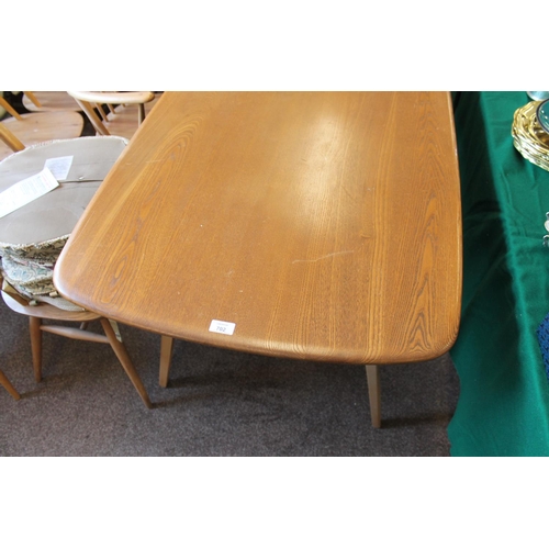 702 - ERCOL DINING TABLE & CHAIRS a light elm and beech dining table with splayed legs (151cms long), also... 