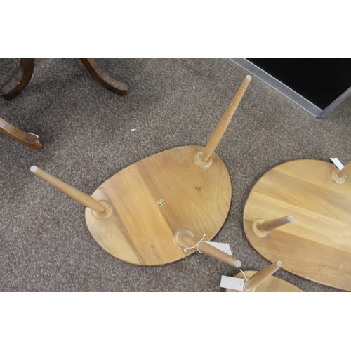 704 - ERCOL NEST OF TABLES - PEBBLE TABLES a set of three light elm and beech pebble coffee tables, one wi... 