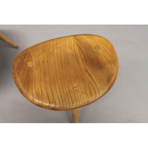 705 - ERCOL 'PEBBLE' TABLES 2 light elm and beech graduated side tables, unmarked. 48cms and 33cms across.... 