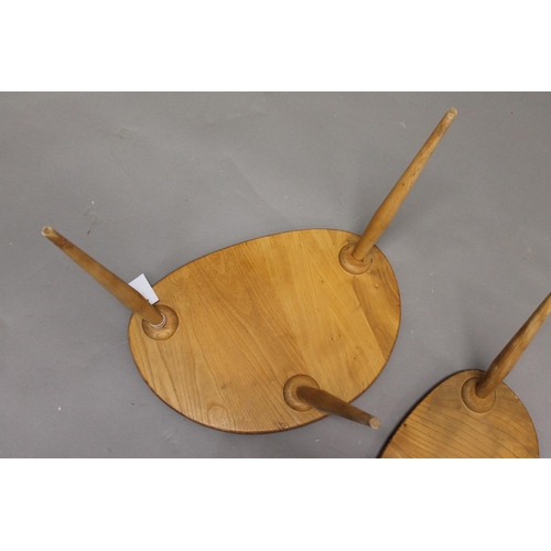 705 - ERCOL 'PEBBLE' TABLES 2 light elm and beech graduated side tables, unmarked. 48cms and 33cms across.... 